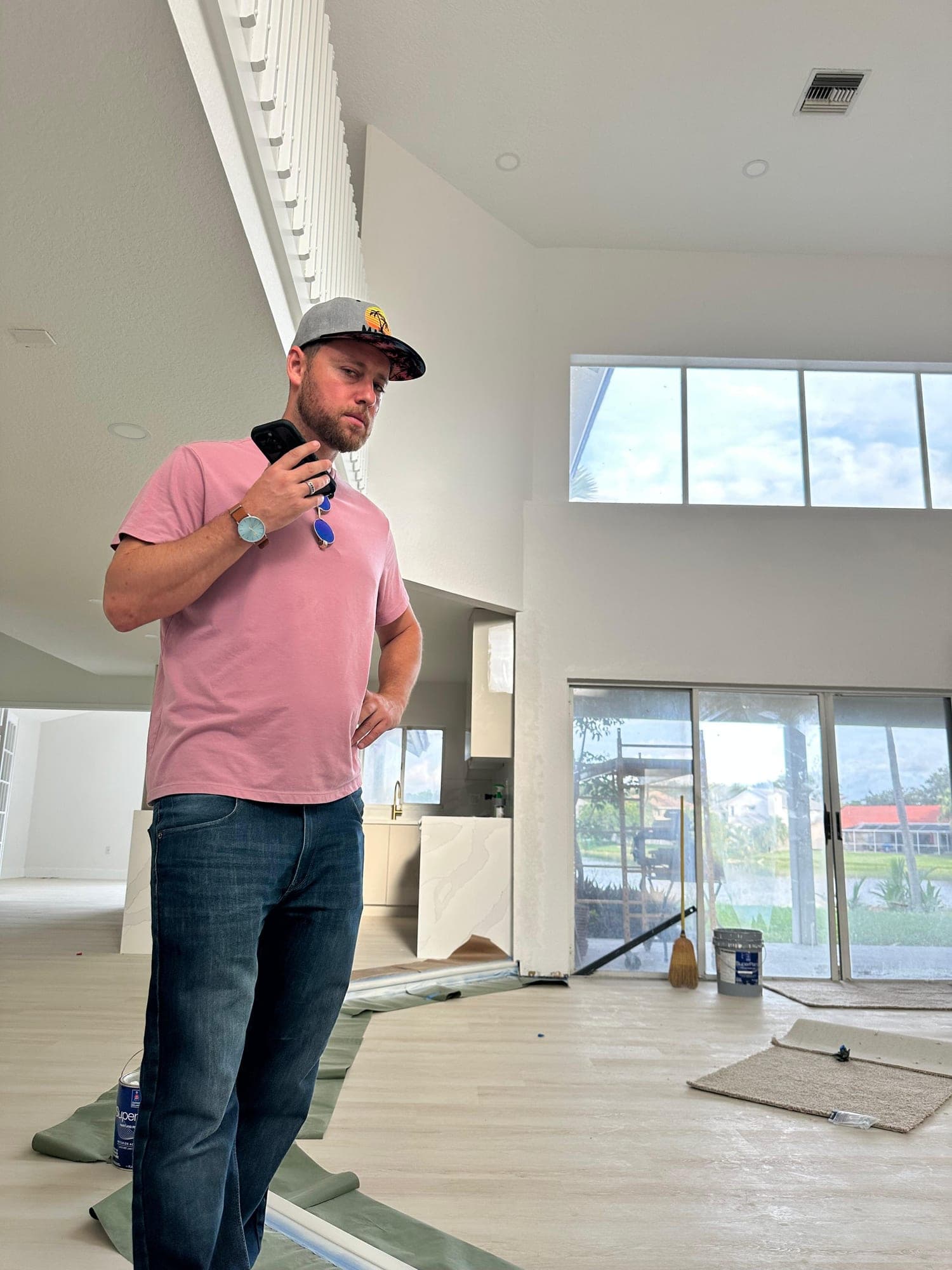 Jonah Stevens walking a home mid-renovation, with fresh paint and new flooring going in