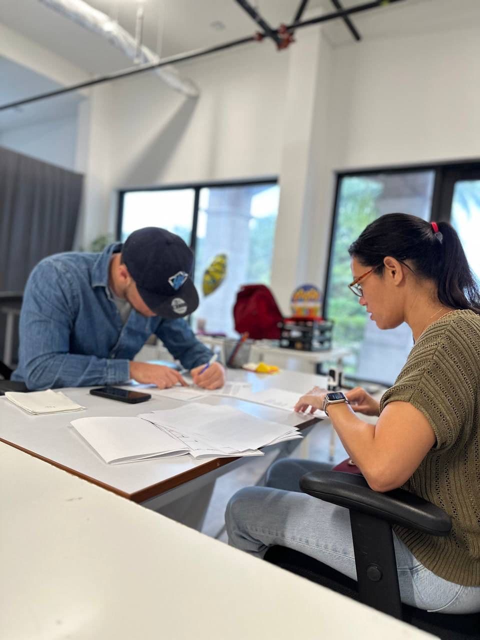 Royal Home Solutions reviewing and signing closing paperwork with a homeowner